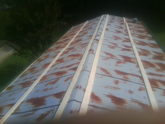 Rusted metal roof panels with new wood purlins before replacement — Storm Damage Roof Repair in Preemption by Roofing Brothers